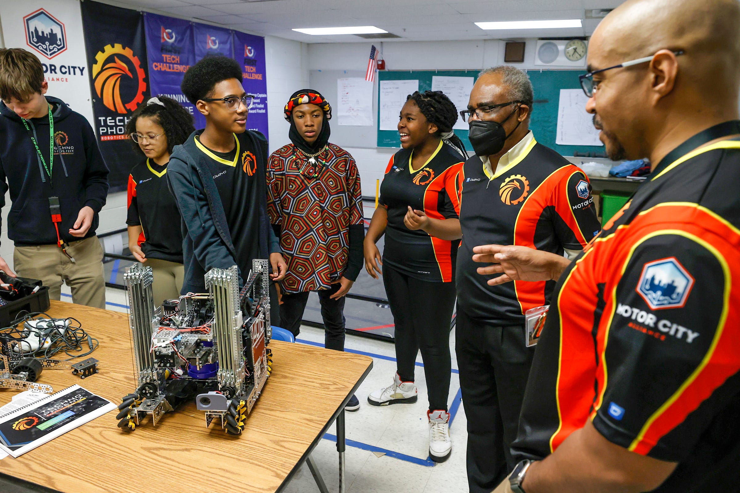 (Center) Aslan Fleming, 13 listens to his coaches Jean-Claude Quenum and Leon Pryor before the start of practice at the Foreign Language Immersion And Cultural Studies School in Detroit on Friday, Feb. 10, 2023. The team qualified for the world robotics championship that happens in Houston, Texas in April and they are the first Detroit middle school to compete in it.