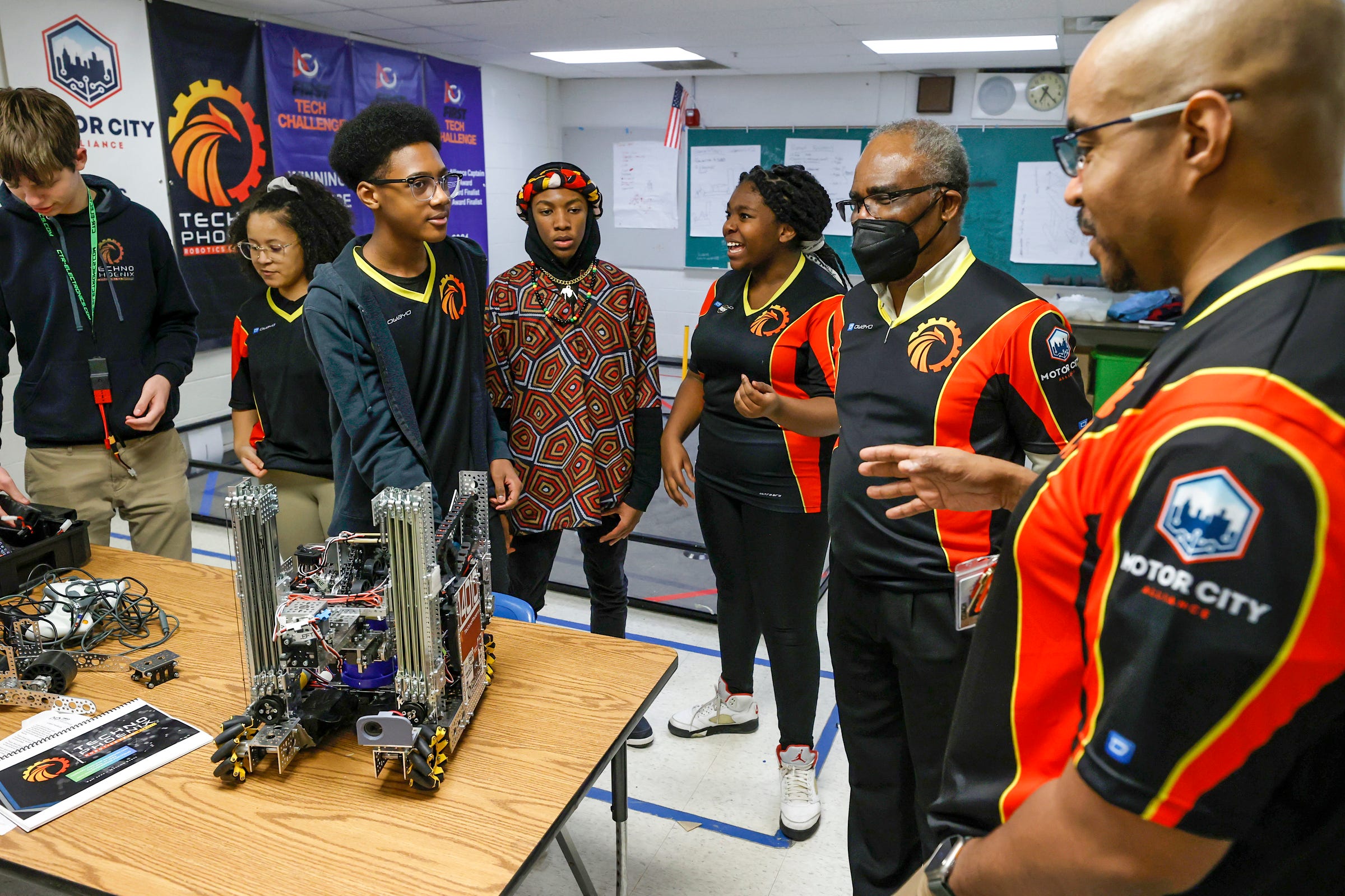 (Center) Aslan Fleming, 13 listens to his coaches Jean-Claude Quenum and Leon Pryor before the start of practice at the Foreign Language Immersion And Cultural Studies School in Detroit on Friday, Feb. 10, 2023. 
The team qualified for the world robotics championship that happens in Houston, Texas in April and they are the first Detroit middle school to compete in it.