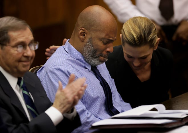 Lamar Johnson, center, and his attorneys react on Feb. 14 after St. Louis Circuit Judge David Mason vacated his murder conviction during a hearing in St. Louis. Johnson served nearly 28 years of a life sentence for a killing that he has always said he didn't commit.