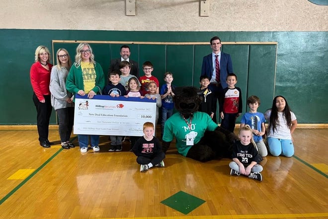 NEW DEAL — Hilltop Securities Inc. honored New Deal Elementary School teacher Carson Graham, third from left, last week with a $10,000 donation to the New Deal Education Foundation and additional prizes for her classroom.