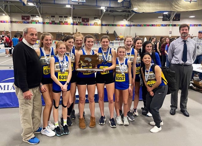 Athletes and coaches from the Whitinsville Christian girls' track team pose after finishing second at the Division 4 state meet at the at the Reggie Lewis Center in Boston on Wednesday.