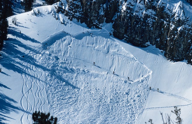 Five backcountry skiers cross a avalanche path while hiking outside of Jackson Hole Resort, Wyoming.