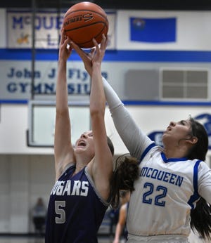 Spanish Spring's Layni Noonkester and McQueen's Jayden Valencia reach for a rebound during Wednesday's playoff game at McQueen High School on Feb. 15, 2023. 