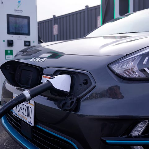A Kia Nero electric vehicle is charged at an Elect