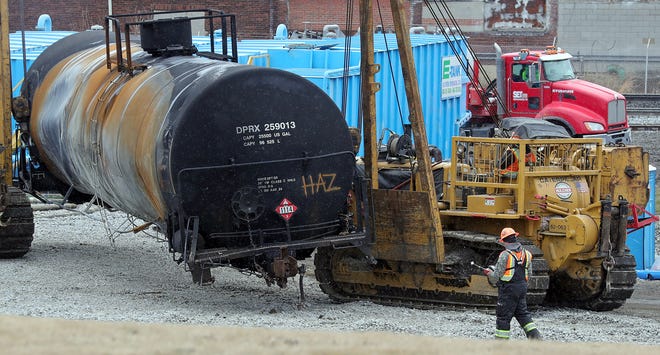Crews work to remove scorched train cars after the Feb. 3 Norfolk Southern train derailment, Friday, Feb. 17, 2023, in East Palestine, Ohio.