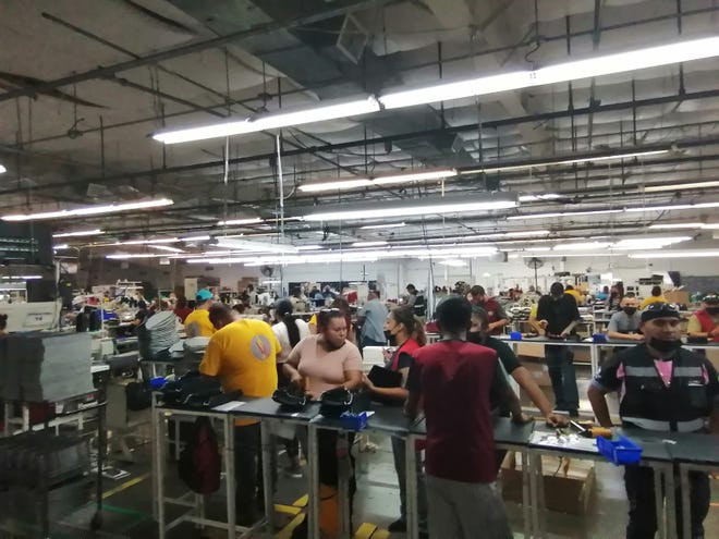 Inside the VU Manufacturing plant in Mexico, workers prepare vinyl and plastic interior pieces for the automotive industry.