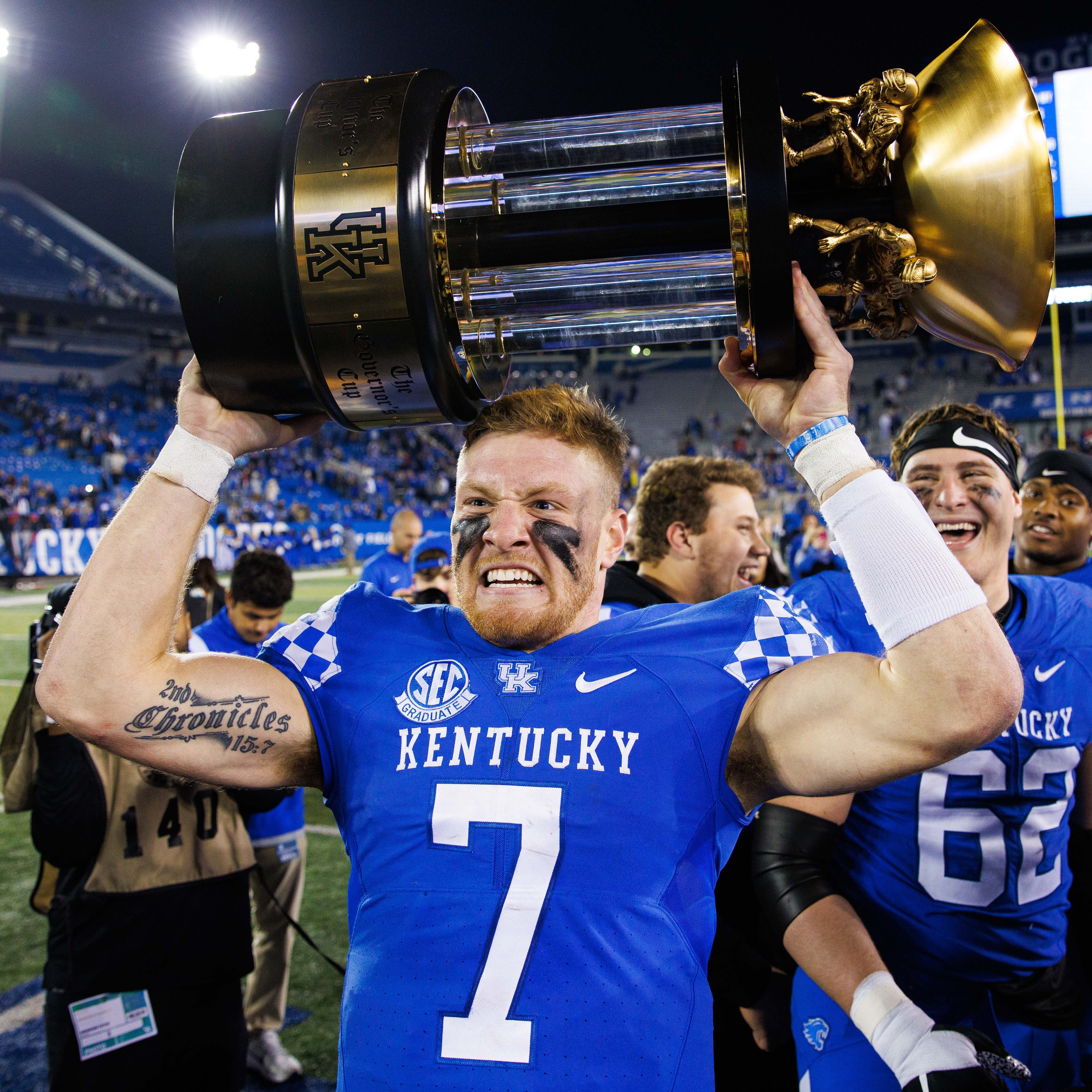 Kentucky Wildcats quarterback Will Levis (7) holds up the Governor's Cup trophy after winning the game against the Louisville Cardinals at Kroger Field.