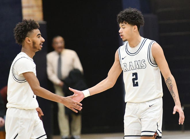 Rochester's Duriel Smith and Jerome Mullins offer encouragement during a WPIAL Class 1A playoff game against Summit Academy Friday night at Rochester Area High School.