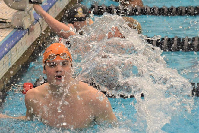 Hope's Ben Catton reacts to winning the 100 butterfly at the MIAA Championships on Friday at Calvin.