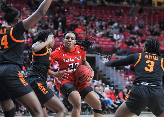 Texas Tech's Bre'Amber Scott, center, drives the ball against Oklahoma State in a Big 12 women's basketball game Saturday, Feb. 18, 2023, at United Supermarkets Arena.
