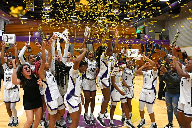 Booker Tornadoes girls celebrate their win with gold confetti in the Class 4A-Region 3 Regional finals 61-48 over the Academy of the Holy Names in front of a packed crowd Friday evening, Feb. 17, 2023, at Tornado Alley in Sarasota.
