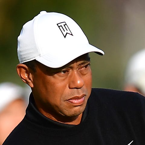 Tiger Woods plays his shot onto the 11th hole fair