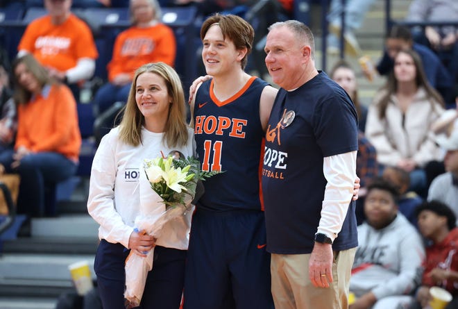 Hope's Brady Swinehart is honored on senior day with his parents on Saturday at DeVos Fieldhouse.