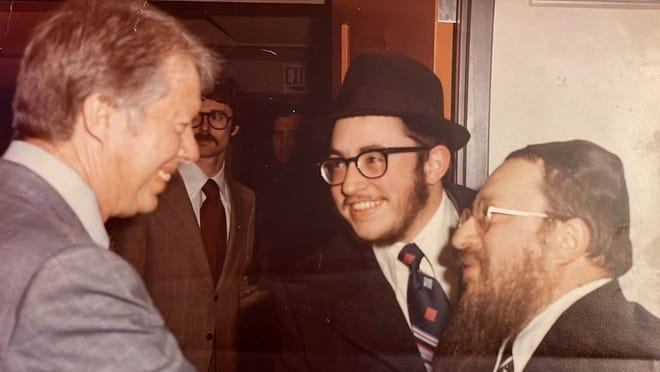 Jimmy Carter greets the Rabbi Hershel Fogelman, right, with Rabbi Mendel Fogelman.