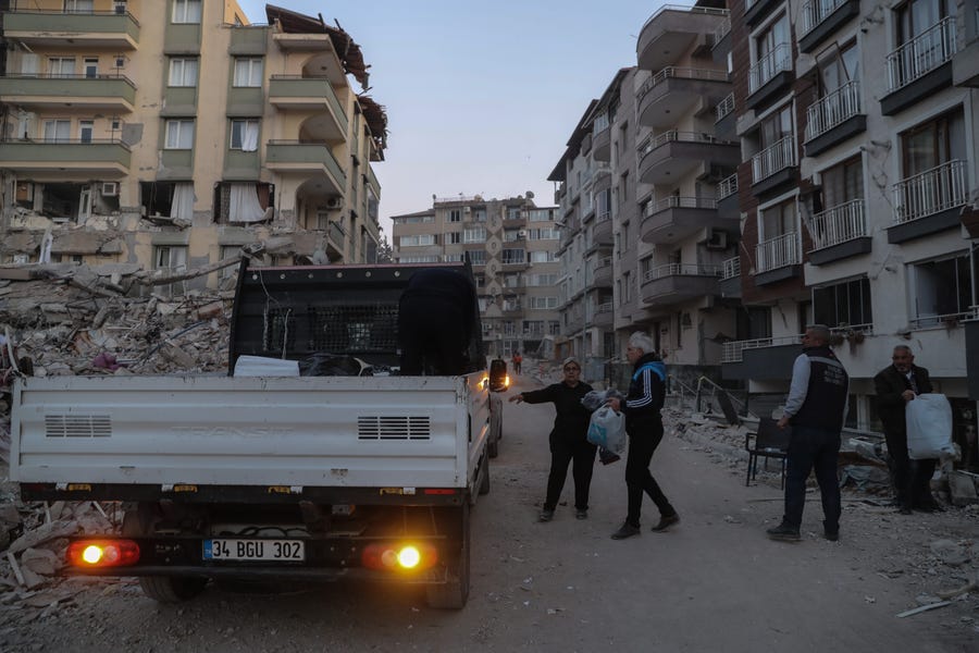 February 20: People carry their belongings from their homes in Hatay, Turkey. A 7.8-magnitude earthquake hit near Gaziantep, Turkey, in the early hours of February 6, followed by another 7.5-magnitude tremor just after midday. The quakes caused widespread destruction in southern Turkey and northern Syria and have killed more than 40,000 people.