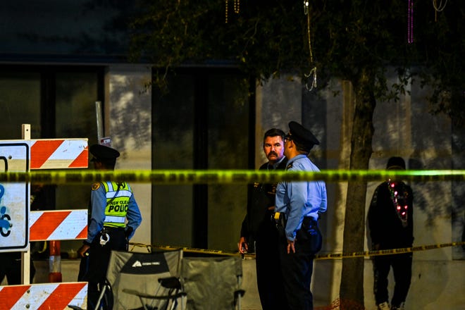 Police officers collect evidence at the scene of a shooting that occurred during the Krewe of Bacchus parade in New Orleans, February 19, 2023.