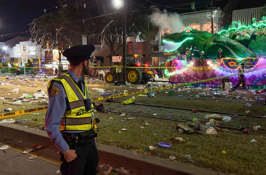 Police work the scene of a shooting at the Krewe of Bacchus parade on Sunday, Feb. 19, 2023.  Five people were shot, including a young girl, during a Mardi Gras parade in New Orleans, police said, and a suspect was in custody.  (David Grunfeld/The Times-Picayune/The New Orleans Advocate via AP) ORG XMIT: LAORS103