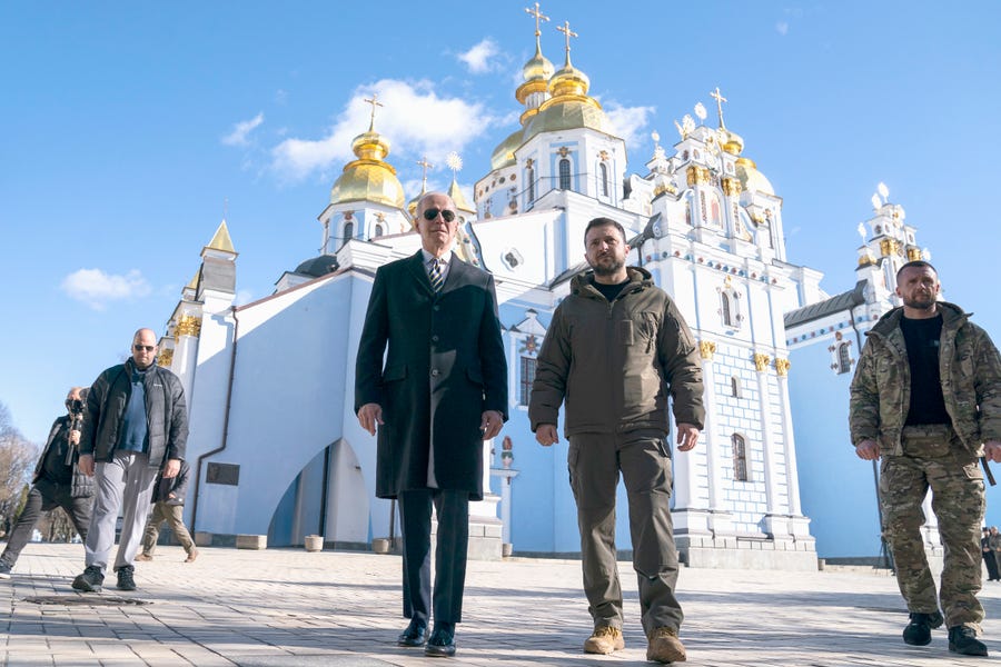 February 20, 2023:  President Joe Biden walks with Ukrainian President Volodymyr Zelenskyy at St. Michael's Golden-Domed Cathedral on a surprise visit, Monday, Feb. 20, 2023, in Kyiv.
