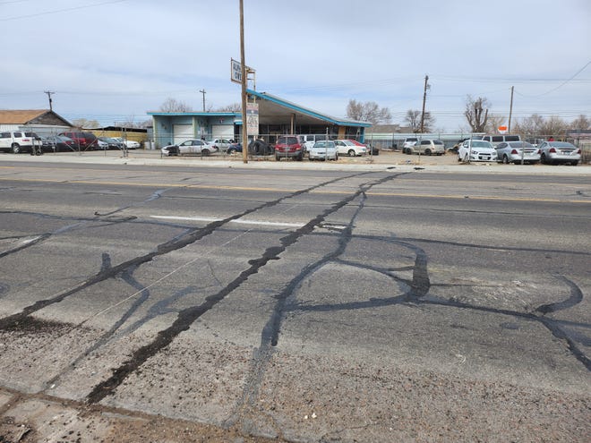 Damage to the roadway can be seen Tuesday afternoon, after a Monday morning train derailment pushed several train cars onto the roadway on Amarillo Boulevard East, blocking traffic for several hours.