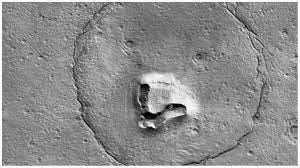 The University of Arizona shared a picture of a feature on the surface of Mars that resembles a teddy bear’s face. The image was captured by the HiRISE camera aboard the Mars Reconnaissance Orbiter (MRO) on Dec. 12, 2022, 155 miles above the surface.