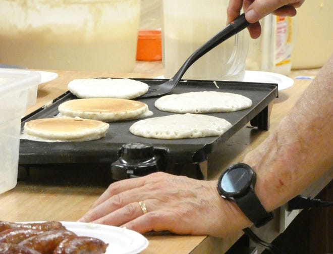 Jim Buck flips pancakes during the Shrove Tuesday pancake supper at St. Paul's Lutheran Church.