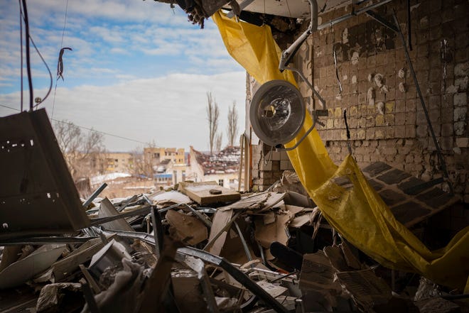 A surgical light hangs from the ceiling of the destroyed surgical section of a hospital in Izium, Ukraine, Sunday, February 18, 2023.