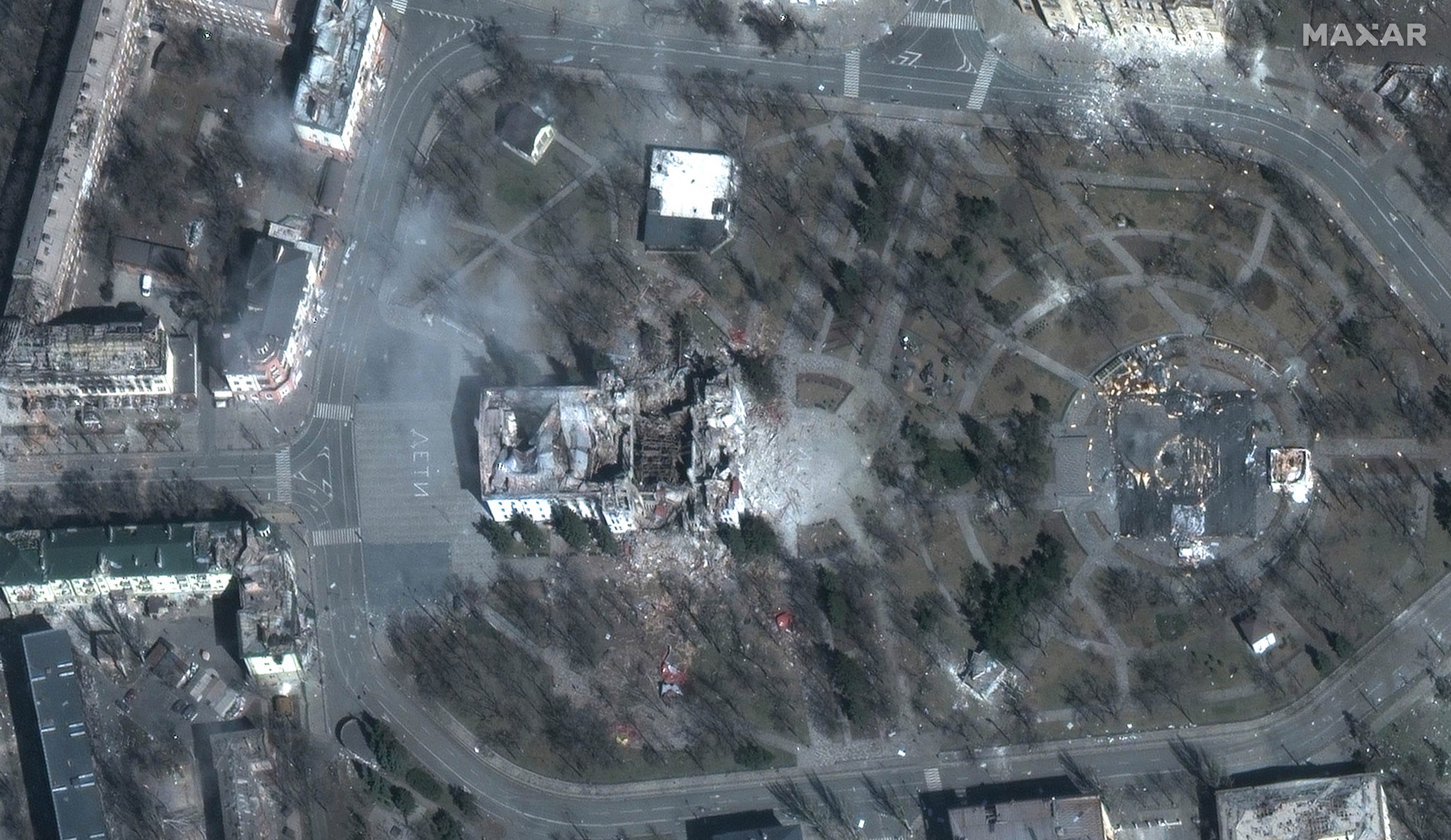 FILE - This combination of satellite images provided by Maxar Technologies shows the destroyed Mariupol, Ukraine Theater on March 29, 2022, top, and a screen built around it seen on Nov. 30, 2022. (Maxar Technologies via AP, File) ORG XMIT: NY487