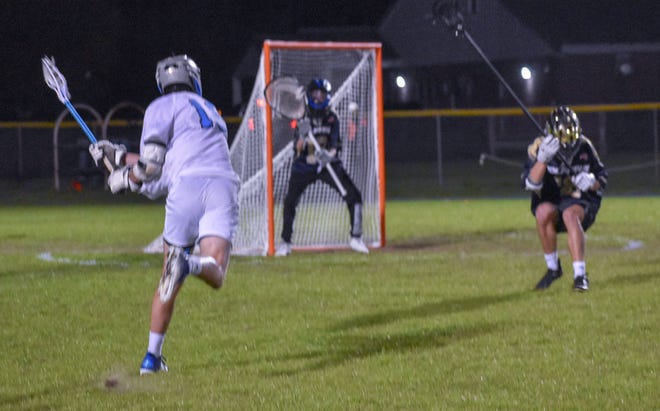 Destin's Paxton Haywood takes a shot at the goal against the Gulf Breeze Dolphins. Haywood scored five pionts in the 13-10 loss.