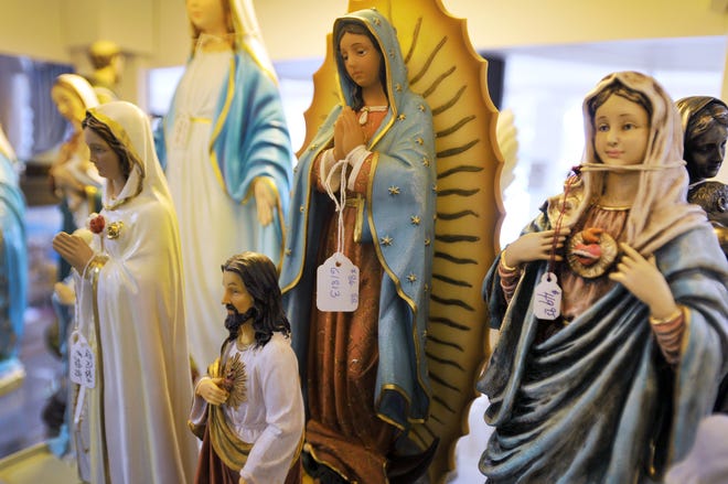 Figures of religious icons were among items for sale at the Queen of Angels Catholic Store in this 2012 photo. The store, which was sold to a new owner in 2017 and now operates on San Jose Boulevard in Mandarin, is suing to challenge Jacksonville's human rights ordinance as an infringement on religious and free-speech rights.
(Photo: Bob Self/Florida Times-Union)