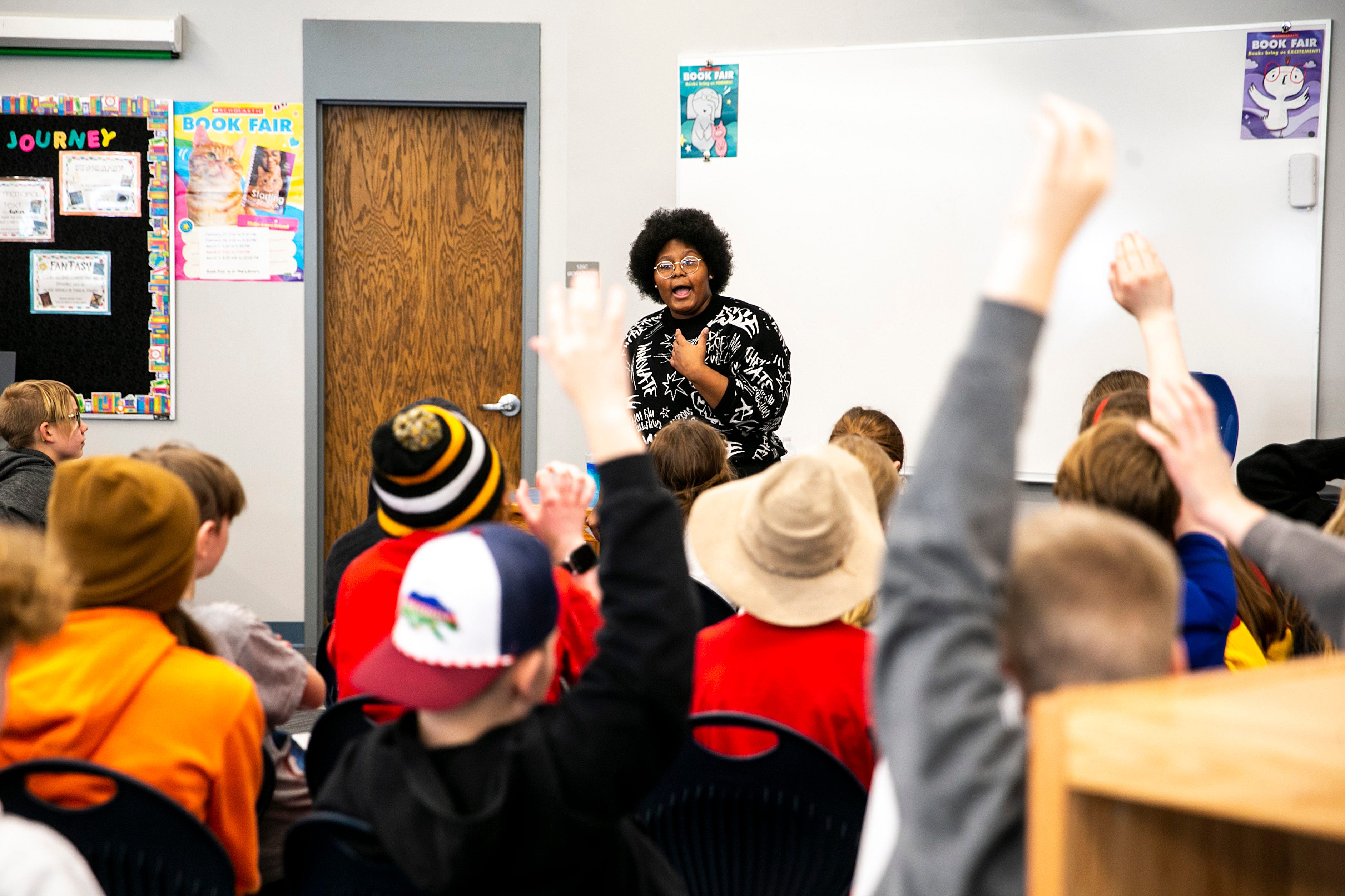 Dasia Taylor talks with fifth and sixth grade students, Tuesday, Feb. 21, 2023, at Shimek Elementary School in Iowa City, Iowa.