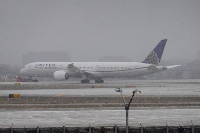 A jet taxis in snow at O'Hare International Airport on December 22, 2022 in Chicago, Illinois. (Photo by Scott Olson/Getty Images)