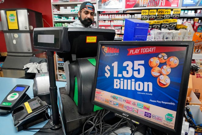 A Mega Million sign displays the estimated jackpot of $1.35 Billion at the Cranberry Super Mini Mart in Cranberry, Pa., Jan. 12, 2023.