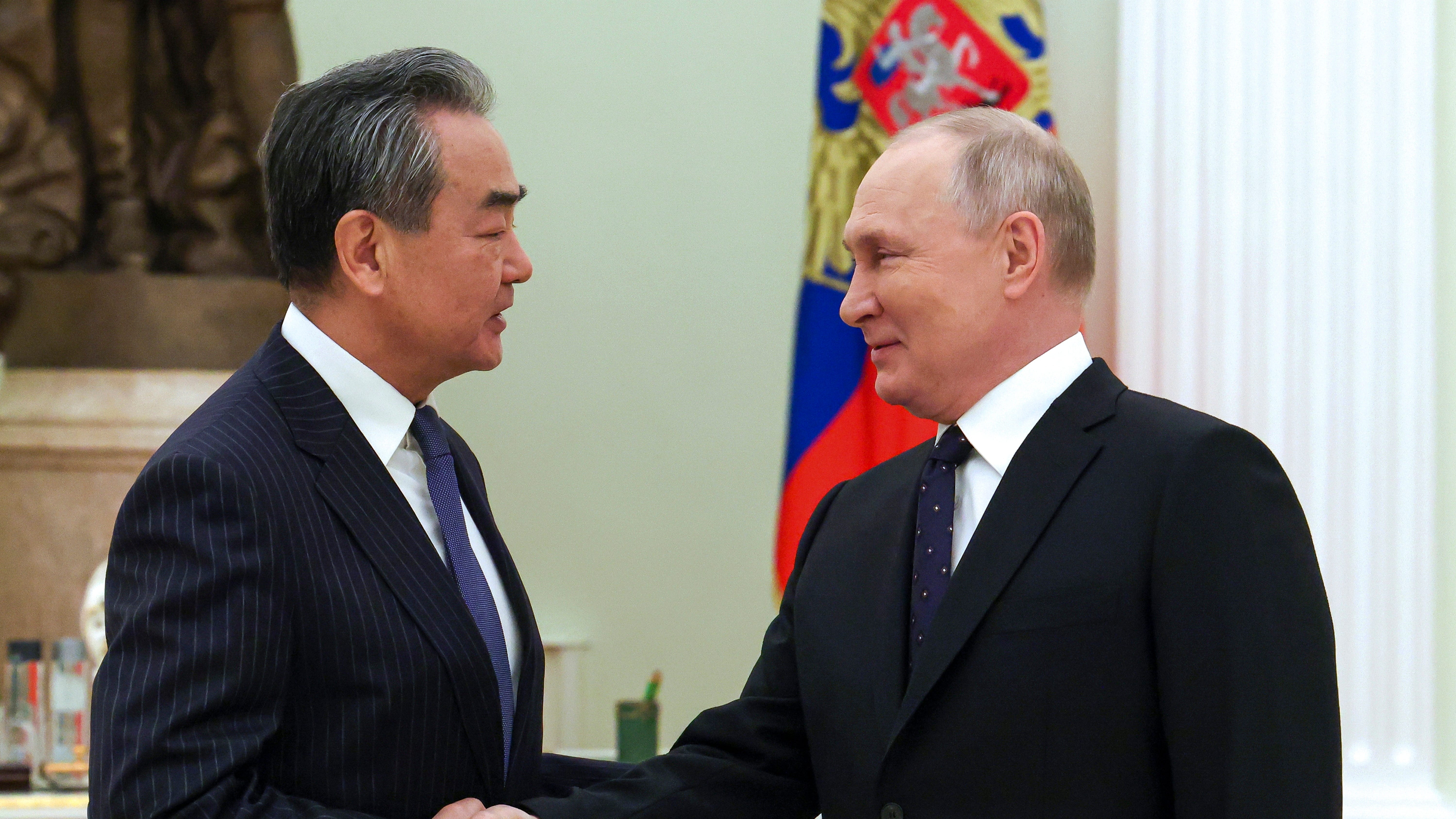 Russian President Vladimir Putin greets Chinese Communist Party's foreign policy chief Wang Yi during their meeting at the Kremlin in Moscow, Russia, Wednesday, Feb. 22, 2023. (Anton Novoderezhkin, Sputnik, Kremlin Pool Photo via AP) ORG XMIT: XAZ117