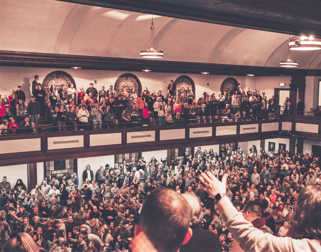 Hundreds of people worship during the revival at Asbury University inside Hughes Auditorium on the campus in Wilmore, Kentucky.