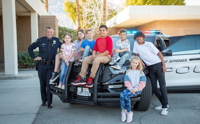 Palm Springs Police Chief Andy Mills poses with kids for a photoshoot for a new valley chapter of a non-profit, Do The Right Thing, that aims to recognize children for good citizenship.