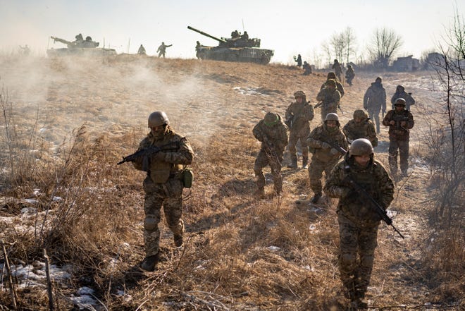 Ukrainian soldiers of the Third Separate Tank Iron Bridge take part in an exercise in Kharkiv region, Ukraine, Thursday, February 23, 2023, one day before the start of the war.  The war was a disaster for Ukraine and a crisis for the world, and the world is a more turbulent and fearful place since Russia invaded its neighbor on February 24, 2022.