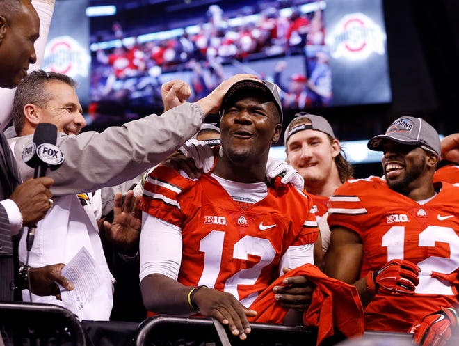 Coach Urban Meyer gives quarterback Cardale Jones a pat on the head after Ohio State crushed Wisconsin 59-0 in last season’s Big Ten championship game.

Adam CairnsDispatch