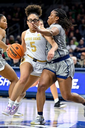 Feb 23, 2023; South Bend, Indiana, USA; Notre Dame Fighting Irish guard Olivia Miles (5) drives to the basket against Georgia Tech Yellow Jackets guard Avyonce Carter (15) in the second half at the Purcell Pavilion. Mandatory Credit: Matt Cashore-USA TODAY Sports