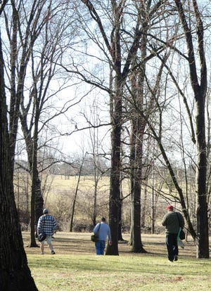 Friends Scott Timmons, Steve Sherman and Dave Clark, from left, take advantage of warm weather late last week for a game of disc golf at Aumiller Park. More unseasonably warm weather is in the forecast for this week, according to the National Weather Service.