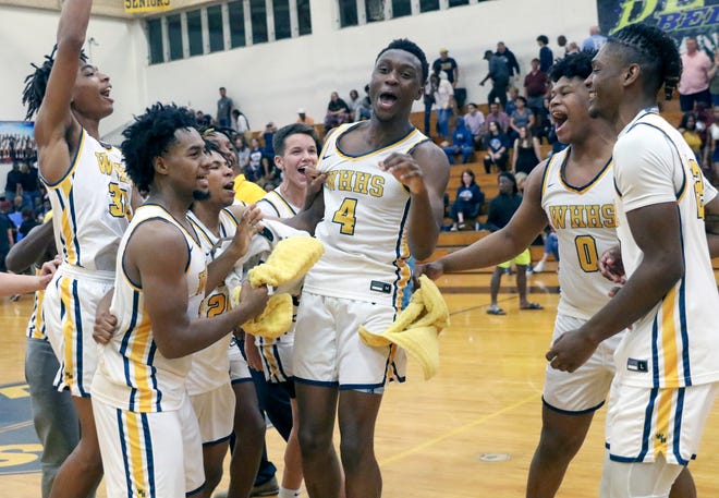 Winter Haven's Isaac Celiscar (4) and Jamie Phillips Jr. celebrate with their teammates after the Blue Devils defeated Newsome on Friday night in the Class 7A, Region 3 final.