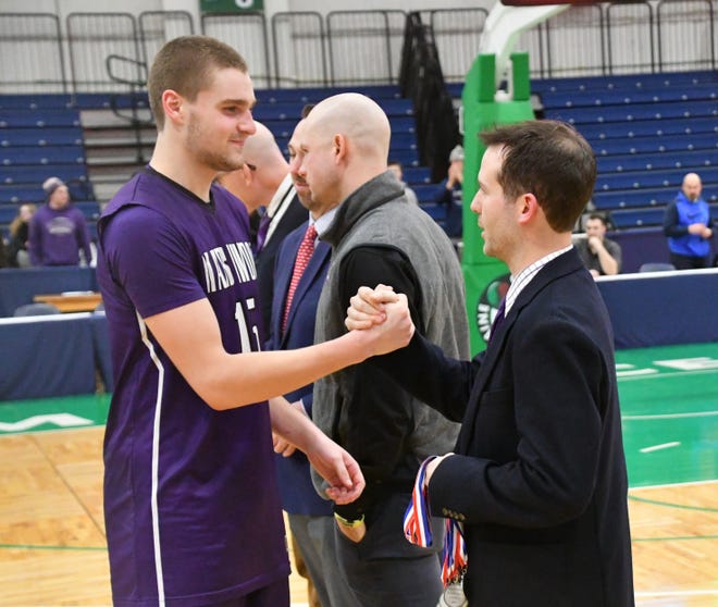 Marshwood’s Andrew Perry, left, is congratulated by coach Bobby Pratt after Friday night’s regional championship game at the Portland Expo