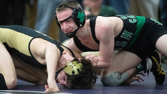 Camden Catholic's Sammy Spaulding, right, defeats Southern's Scottie Sari, 8-2, during a 120 lb. bout of the quarterfinal round of the Region 7 wrestling tournament at Cherry Hill East High School on Friday, February 24, 2023.  