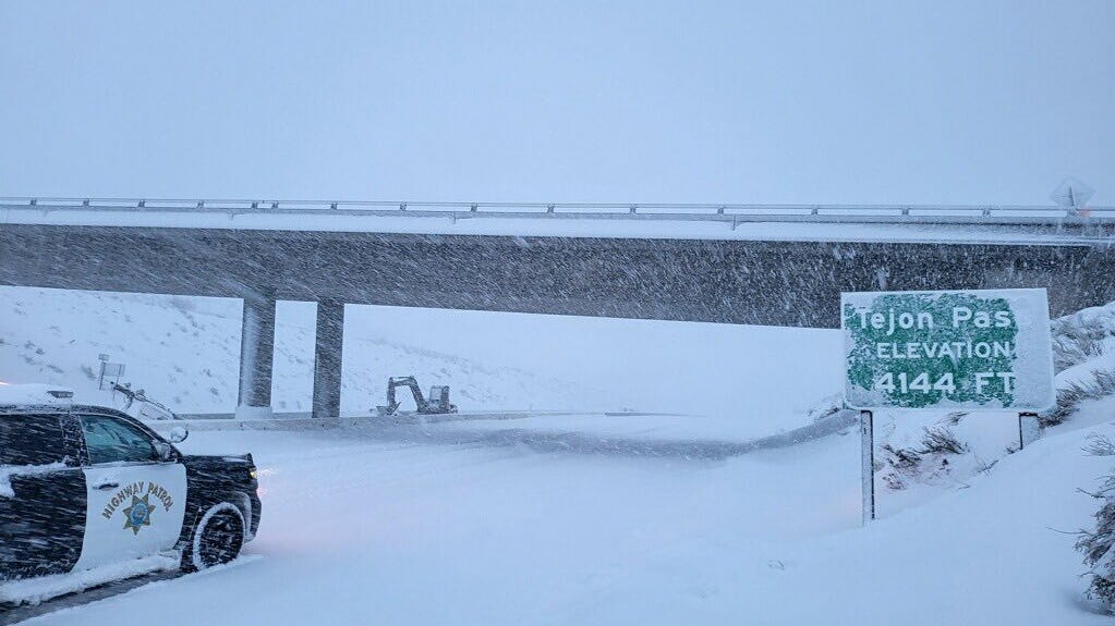 A California Highway Patrol vehicle navigates snow and ice that closed the Grapevine section of Interstate 5 over Tejon Pass Saturday morning, Feb. 25, 2023.