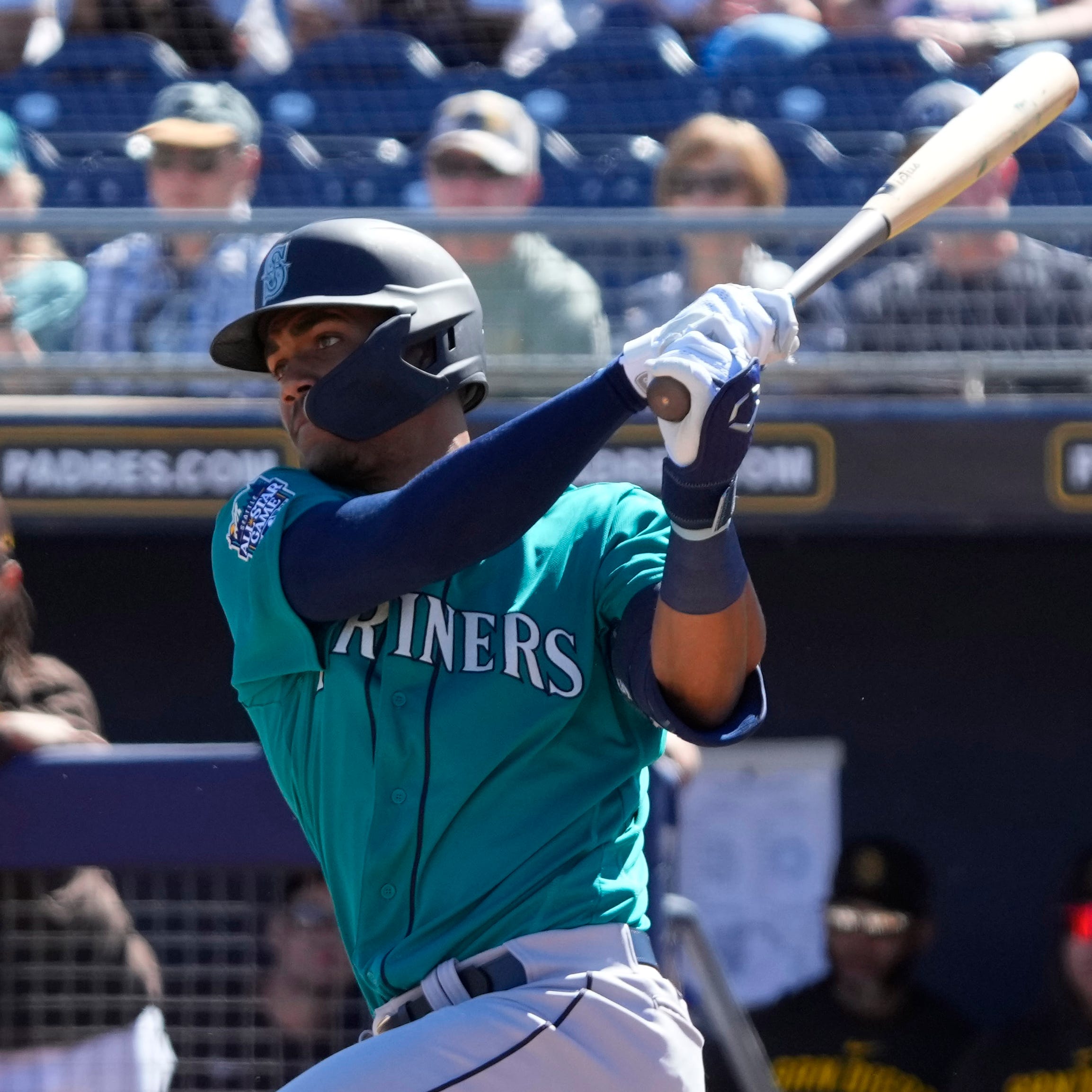 Seattle Mariners center fielder Julio Rodriguez hits a single against the San Diego Padres in the first inning of a spring training game on Friday.