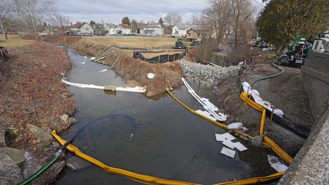 Crews aerate water from Leslie Creek, left, and Sulphur Run where they come together in East Palestine City Park.