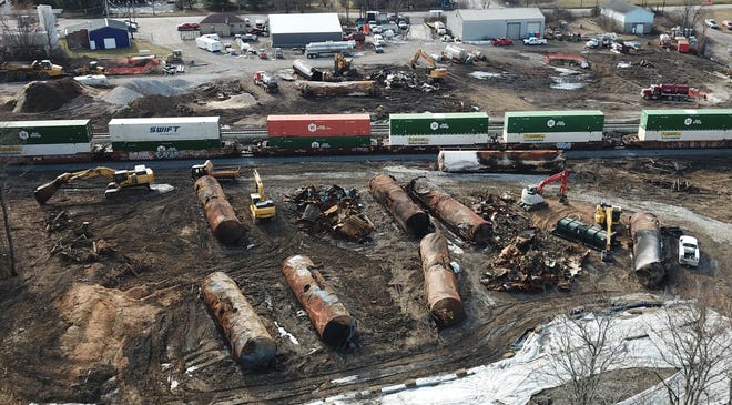 As cleanup continues on Saturday, Feb. 25, 2023, a train rolls past the site of the East Palestine, Ohio Norfolk Southern train derailment that released hazardous chemicals into the town's ground and water. Norfolk Southern said that 15,000 pounds of contaminated soil and 1.1 million gallons of contaminated water excavated from the derailment site will be transported to landfills and disposal facilities designed "to accept it safely in accordance with state and federal regulations."