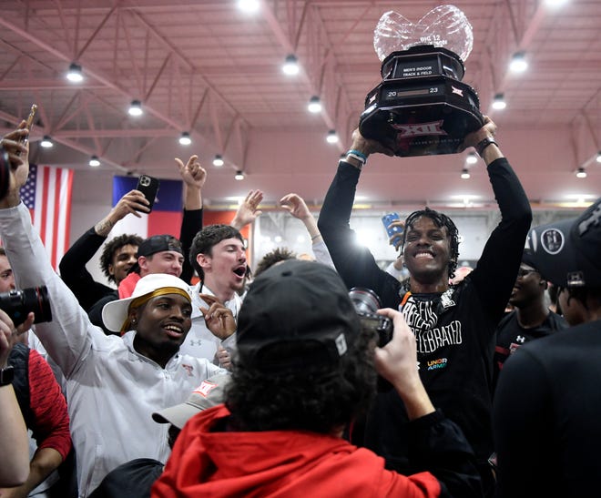 Texas Tech's Terrence Jones takes his turn raising the trophy after the Red Raiders won the Big 12 indoor track and field championship Saturday at the Sports Performance Center. Jones won the 60 meters in 6.48 seconds, the fastest time in NCAA Division I this season.