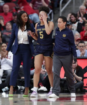 Notre Dame's Olivia Miles (5) was lead off the court by head coach Niele Ivey, left, after she was injured and had to leave the game against U of L during their game at the Yum Center in Louisville, Ky. on Feb. 26, 2023.
Uofl Dame20 Sam