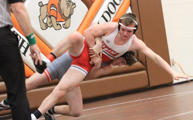 Elgin junior Kaiden Luikart takes Utica sophomore Robert Cotsamire to the mat in a 150-pound match during the Division III sectional tournament at Heath on Saturday, Feb. 25, 2023. Luikart won the championship.