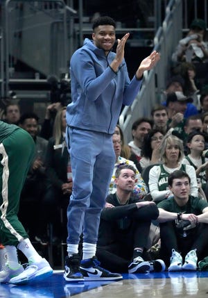 Milwaukee Bucks forward Giannis Antetokounmpo cheers from the bench during the Bucks' game against the Phoenix Suns Feb. 26, at Fiserv Forum. He will miss Tuesday's game against the Orlando Magic witha  non-COVID-19 illness.